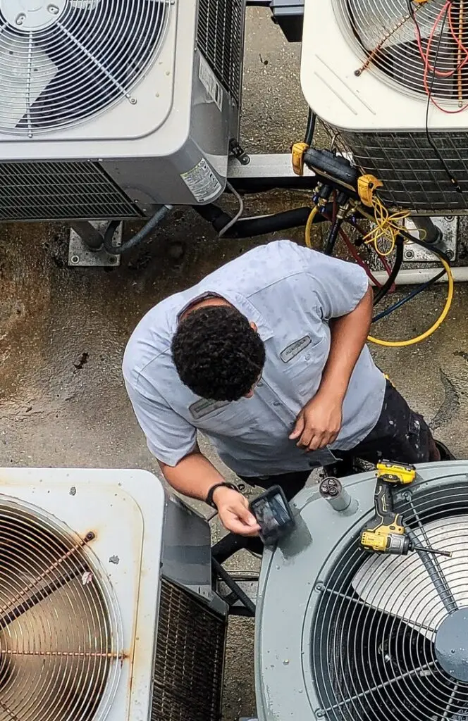 HVAC Business Owner working on units.